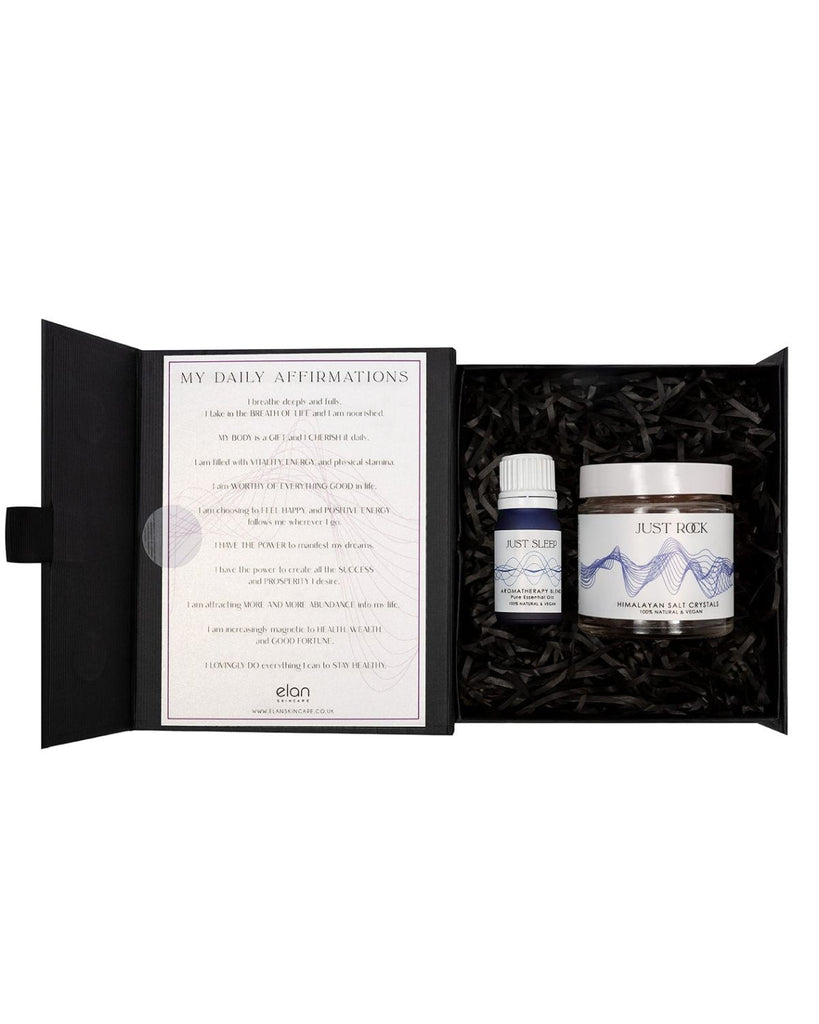 Sleep gift set from Elan Skincare, Aromatherapy blend of pure essential oils in a blue bottle, a jar of Himalayan salt crystals placed in a box, with my daily affirmations card fixed to the inside lid of the box